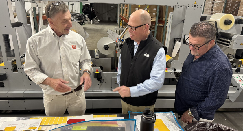 Mark Davenport (middle) and John Abbott (R) provide Nick Mandrycky with an insider's tour of Abbott Label's facility.